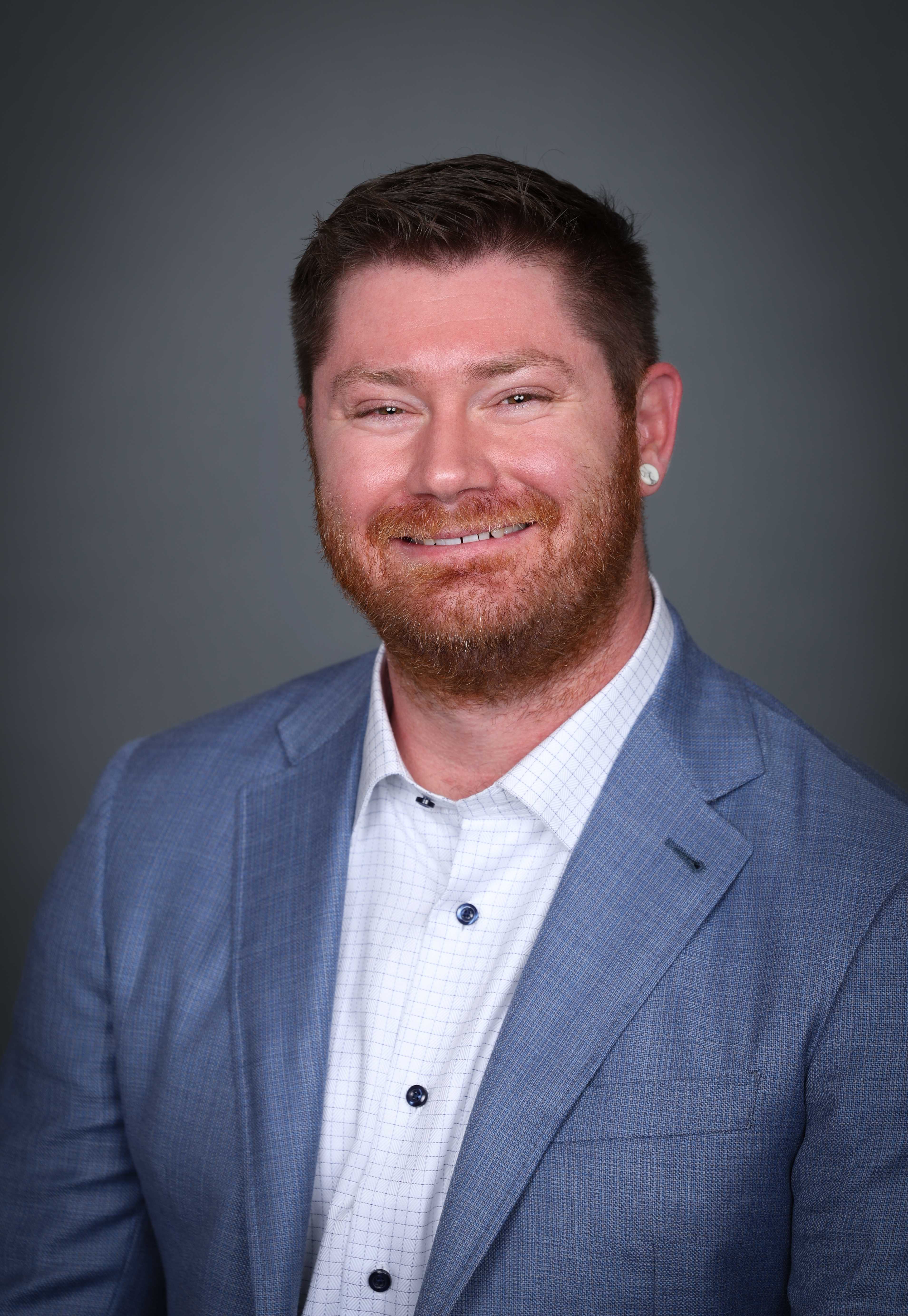 photo of STeve Collins wearing a blue jacket and white button up shirt